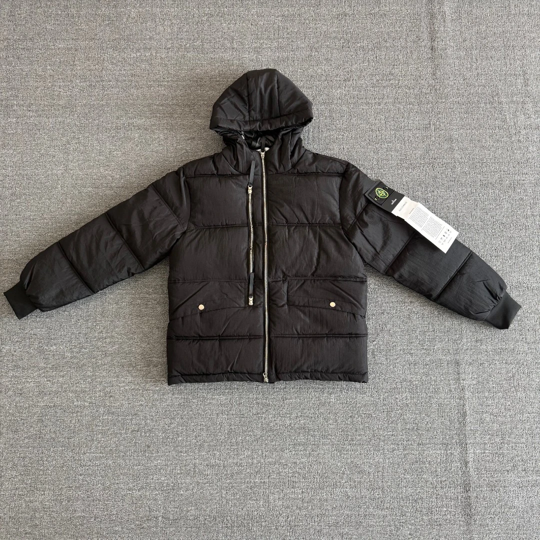 Stone Island Crinkle Reps hooded jacket featuring the signature compass sleeve badge; a windproof, warm, and versatile piece.