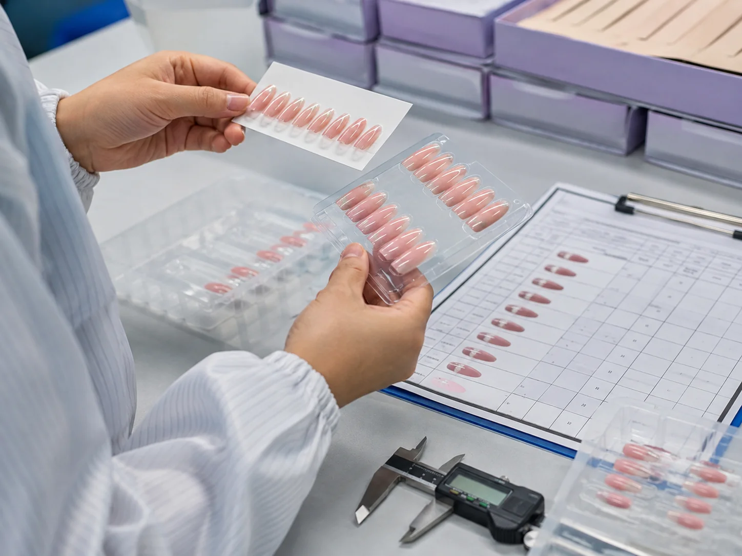 Inspector comparing press on nail sizes and surface finish with the approved production sample