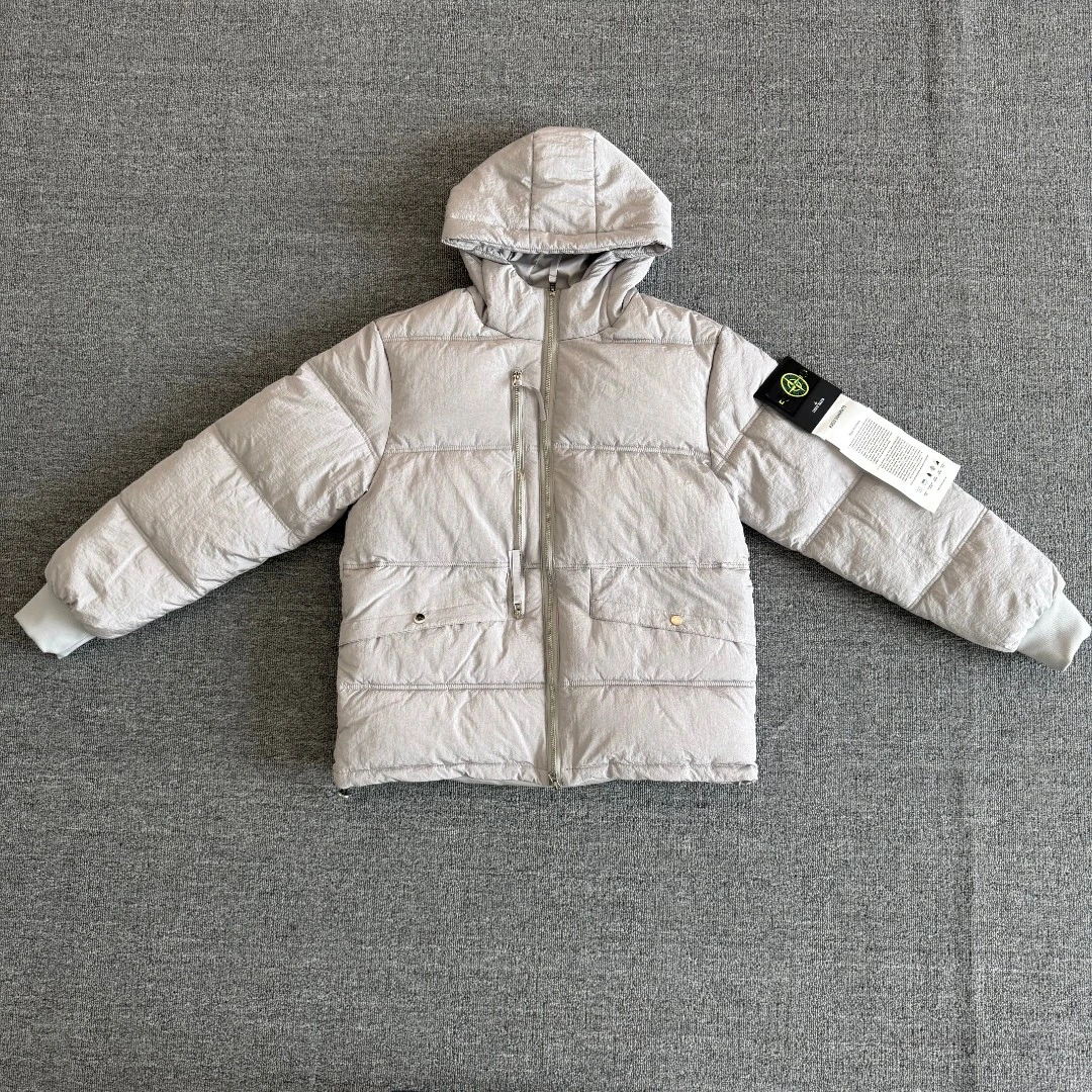 Stone Island Crinkle Reps hooded jacket featuring the signature compass sleeve badge; a windproof, warm, and versatile piece.