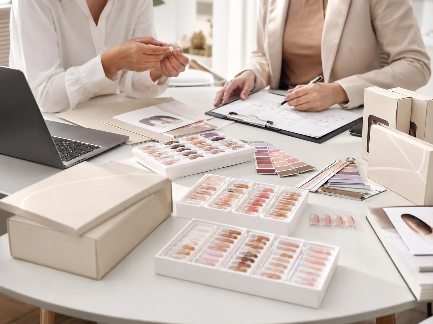 Buyer reviewing press on nail samples, packaging, and project specifications with a manufacturer