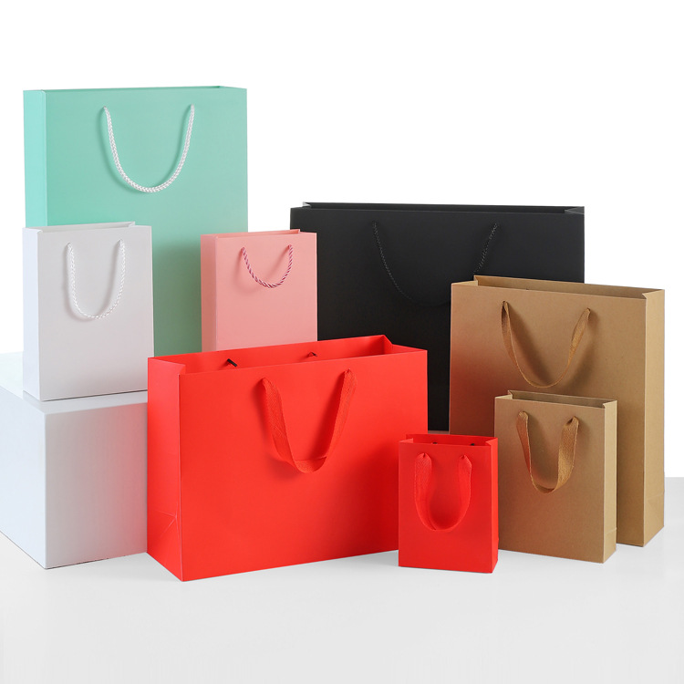 In Stock Wholesale Kraft Paper Gift Bag, Multi-Purpose Handheld Shopping Bag For Clothing, Women Wear, Flower, Eyewear And Gift Packaging With Custom Print