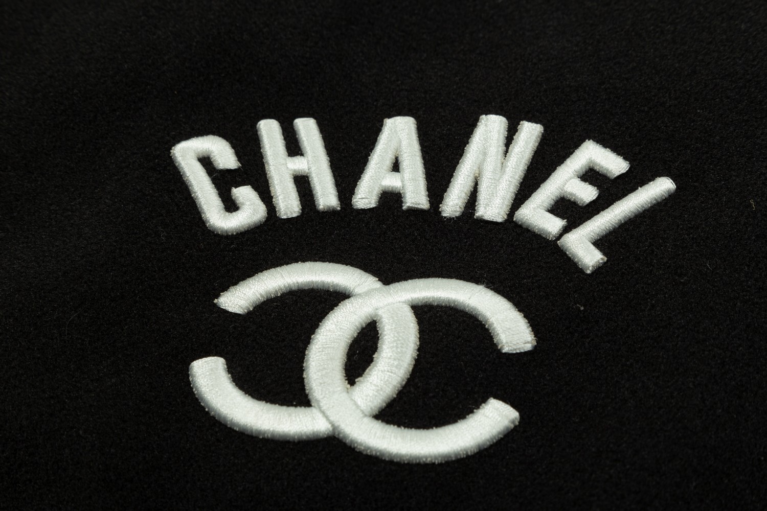 CHANEL spliced flocked embroidered baseball jacket. It has baked lacquer flat all-surface four-piece buttons (the buttons bear the logo).