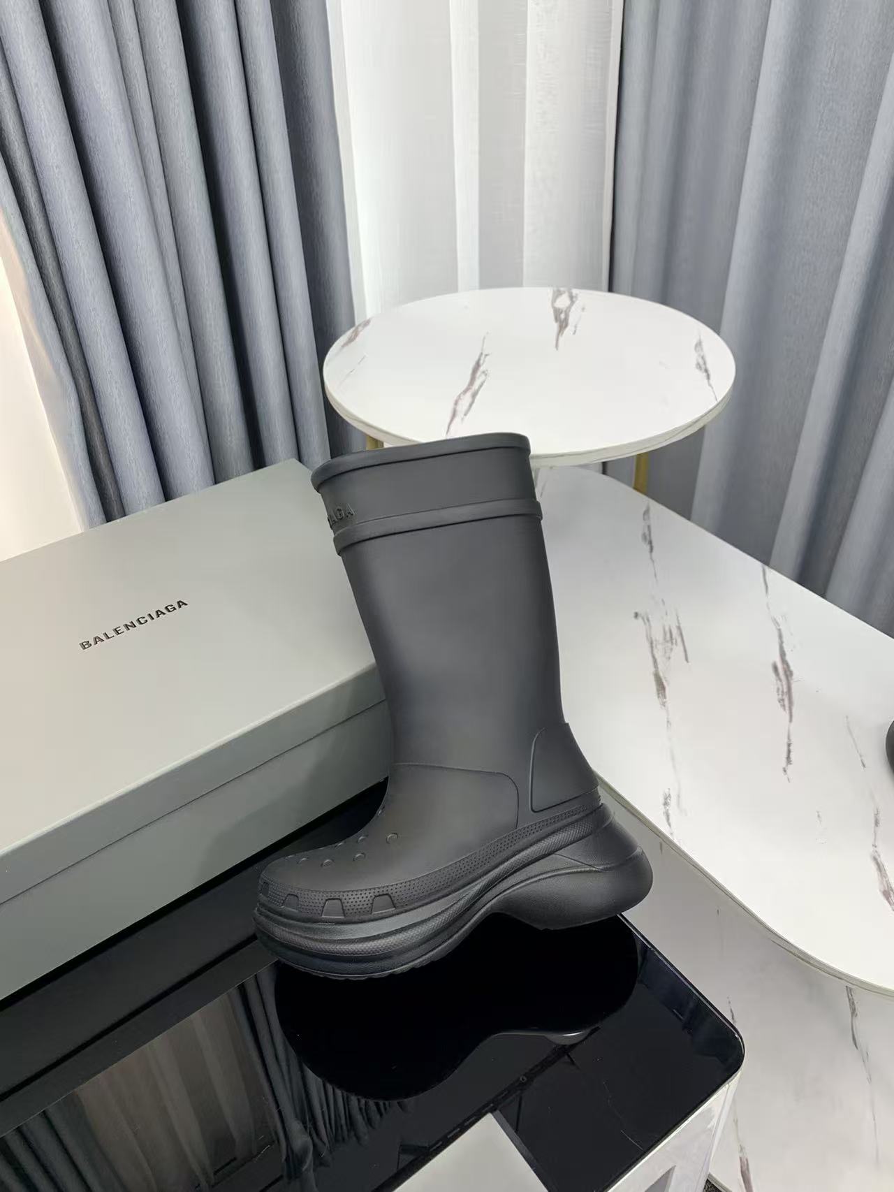 Balenciaga collaborates with Crocs on new hole-shaped rain boots