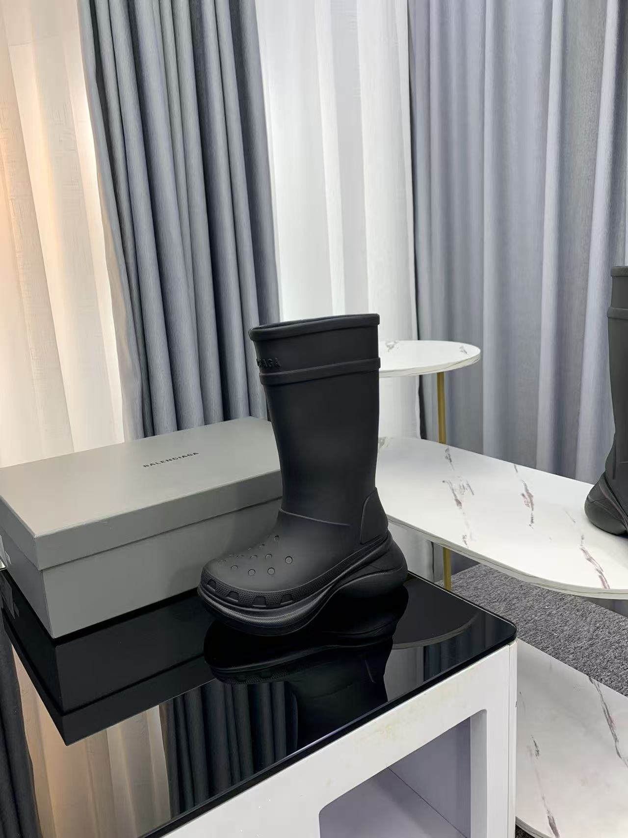 Balenciaga collaborates with Crocs on new hole-shaped rain boots