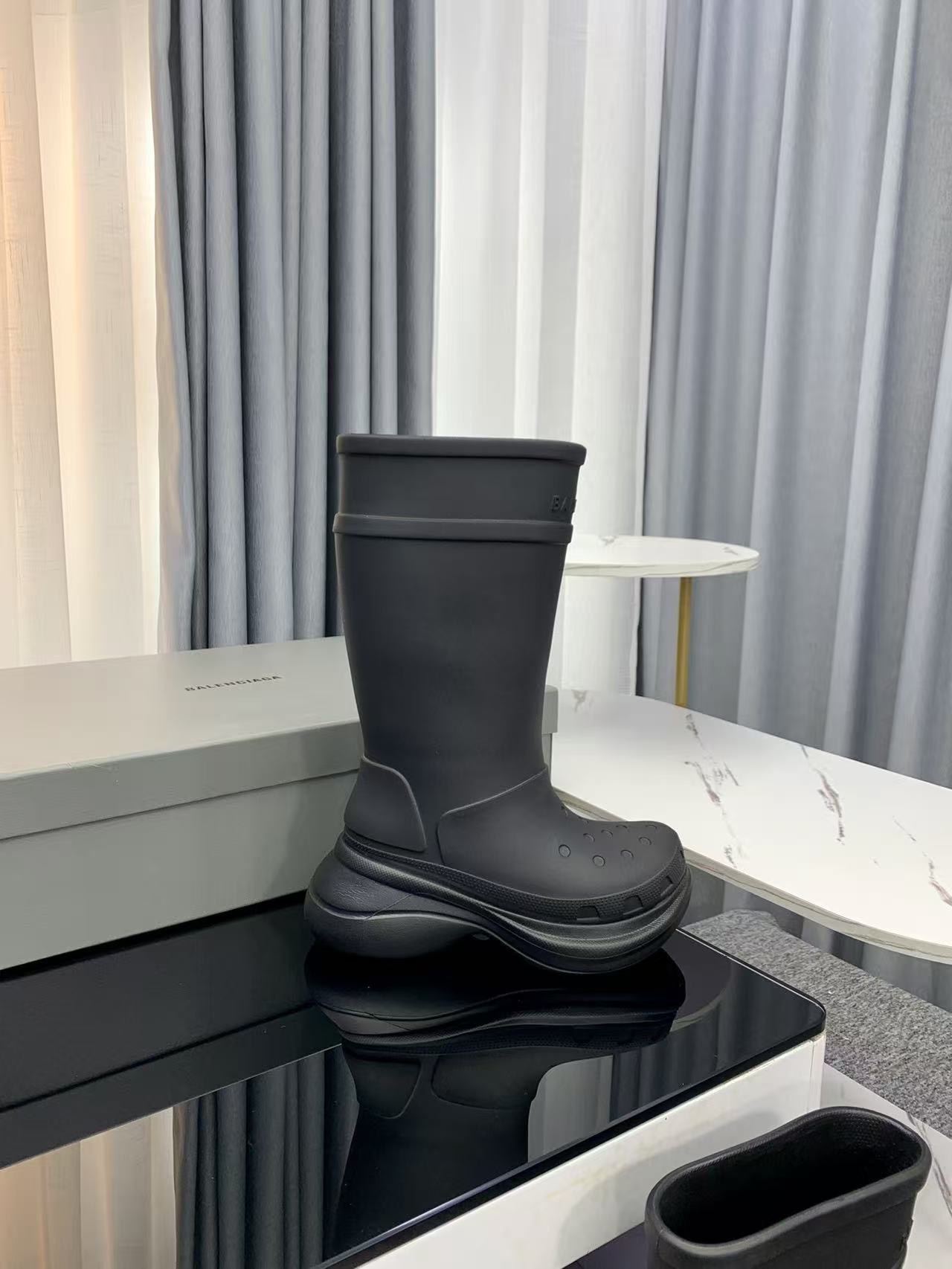 Balenciaga collaborates with Crocs on new hole-shaped rain boots